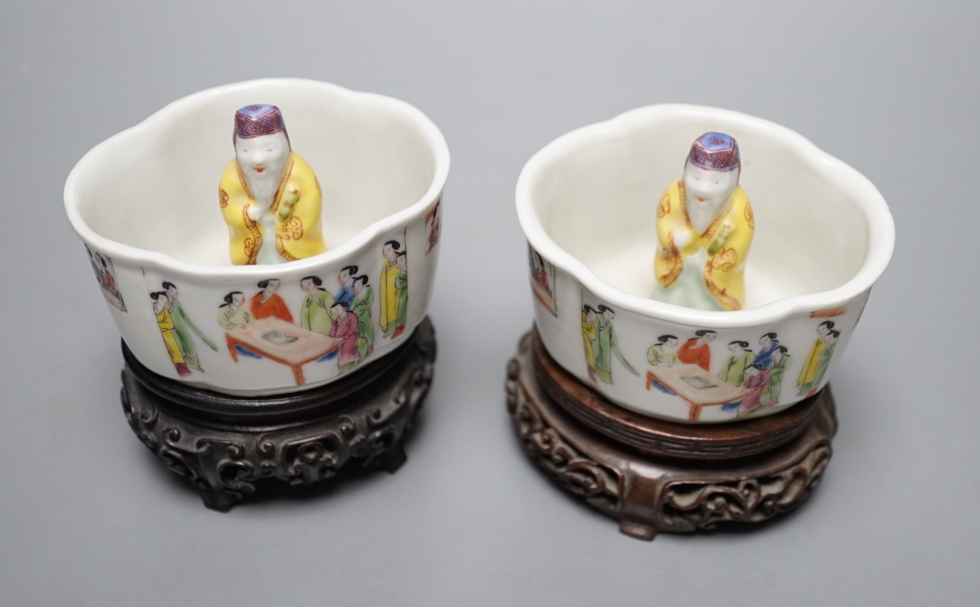 A pair of 19th century Chinese famille rose puzzle cups on stands, 8cm tall overall